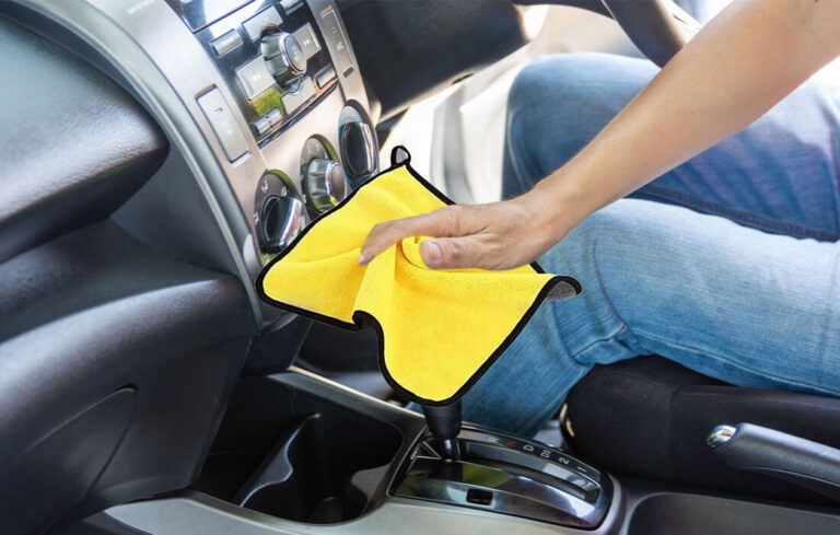A person cleaning car interior with a microfiber car cleaning cloth by MaxOshine